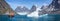 Panorama of Zodiac alongside an iceberg  with passengers in front of large glacier in Evighedsfjord, Greenland