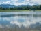 Panorama of Zovnesko jezero or Zovnek lake in Slovenia, on a hot summer day. Visible man made dam in the background used for