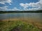 Panorama of Zovnesko jezero or Zovnek lake in Slovenia, on a hot summer day. Visible man made dam in the background used for