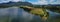 Panorama of Zovnesko jezero or Zovnek lake in Slovenia, on a hot summer day. Visible parked adventure camper van on the peninsula