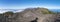 Panoramatic view of volcanic landscape with lush green pine trees, colorful volcanoes and white clouds at path Ruta de