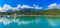 Panoramia of tropical lagoon and lush mountains and the ocean in