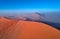 Panoramic, aerial, artistic photo of Namib dunes.  Early morning Namib desert covered in mist. Orange dunes of Namib from above.