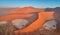 Panoramic, aerial, artistic photo of Namib dunes.  Early morning Namib desert covered in mist. Orange dunes of Namib from above.