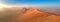 Panoramic, aerial, artistic photo of Namib dunes.  Early morning Namib desert covered in mist. Orange dunes of Namib from above.