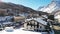 Panoramic aerial drone scenic view at ski slopes, mountain skiing and popular resort town. Italian ski resort in Alps in