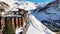 Panoramic aerial drone scenic view at ski slopes, mountain skiing and popular resort town. Italian ski resort in Alps in