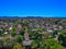 Panoramic Aerial Drone view of Suburban Sydney housing, roof tops, the streets and the parks