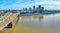 Panoramic aerial rose gold truss bridge over Ohio River heading into skyscraper center Louisville