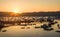 Panoramic aerial shot of a harbor with boats and ships  under an orange sky at sunset