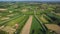 Panoramic aerial top drone view of modern speed highway. Picturesque road among the green fields.