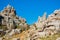 Panoramic aerial top view of mountains stones of El Torcal natural park,a lot of trees and wild goat greezing near the path on