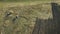 Panoramic aerial view of agricultural cultivated field with tractor performing fall tillage