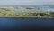 Panoramic aerial view of amazing calm landscape with flood-meadow near river in spring day in sunny weather