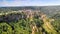 Panoramic aerial view of Civita di Bagnoregio from a flying drone around the medieval city, Italy