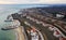 Panoramic aerial view of the cottage settlement by sea. Top view of the marine cottage village, line of strengthening the coast in