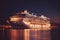 A panoramic aerial view of a cruise ship at night, featuring smart services. Generative AI