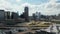 Panoramic aerial view of downtown skyscrapers behind rush highway. Tall modern office building panning footage from