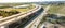 Panoramic aerial view elevated expressway through water zone and construction site