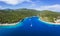 Panoramic aerial view of Foki Beach and sailing yacht boats moored in turquoise bay. Fiskardo, Kefalonia island, Greece