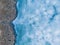 Panoramic aerial view of a frozen lake with animal footprints. Animal tracks on the frozen surface of the lake