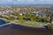 Panoramic aerial view of the Gostiny Dvor Arcade in Veliky Novgorod, autumn treetops on a sunny day. Remaining ruins of