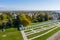 Panoramic aerial view of the Gostiny Dvor Arcade in Veliky Novgorod, autumn treetops on a sunny day. Remaining ruins of