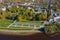 Panoramic aerial view of the Gostiny Dvor Arcade in Veliky Novgorod, autumn treetops on a sunny day. Remaining ruins of