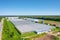 Panoramic aerial view of the large glass greenhouse for the cultivation of vegetable crops and flowers