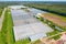 Panoramic aerial view of the large glass greenhouse for the cultivation of vegetable crops and flowers