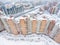 Panoramic aerial view at the long residential building with inner yard with parked cars at winter season. St.Petersburg, Russia.