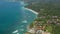 Panoramic aerial view of luxury holiday homes and resorts on top of the cliff overlooking blue ocean in Bali, Indonesia