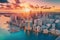 A panoramic aerial view of the Miami skyline at sunset, showcasing the city\\\'s iconic pastel-colored buildings