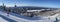 Panoramic aerial view of Mont and Lake Tremblant in winter with skiers on slope downhill, Quebec