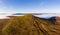 Panoramic aerial view of a mountain summit rising above a sea of low cloud and fog Sugar Loaf, Wales