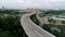 Panoramic aerial view of river bridge in the city with trees in parks. Shot. Aearial view of the bridge with cars