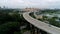 Panoramic aerial view of river bridge in the city with trees in parks. Shot. Aearial view of the bridge with cars