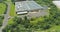 Panoramic aerial view on solar panels on absorb sunlight sustainable energy of building warehouse roof near small