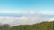 Panoramic aerial view - thick clouds in the mountains above the evergreen forest on Tenerfe, Canary Islands, Spain