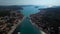 Panoramic aerial view to the neighborhood of a picturesque Croatian town, divided by a strait and connected by a bridge.