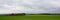 Panoramic Ardennes landscape, Lush green fields, with hills and forests on a misty cloudy day