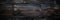 Panoramic banner of burned wood texture, charred black timber background. Abstract pattern of dark burnt scorched tree. Concept of