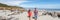 Panoramic banner of Couple walking on beach in New Zealand - people in Ship Creek on West Coast of New Zealand. Tourist