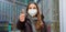 Panoramic banner cropped view of thumbs up woman wearing protective face mask and winter clothes in the city