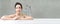 Panoramic banner image of young beautiful Asian lady relaxing and looking away while sitting in the bathtube.Spa treatments for