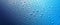 Panoramic banner of water drops on blue metal