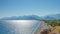 Panoramic bird view over Antalya modern part of the city, Mediterranean seacoast and long pebble beach with tourists, Antalya,