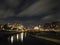 panoramic cityscape view of leeds at night from the river aire with crown point bridge and apartments reflected in the water and