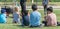 Panoramic close-up rear view multicultural children on grass meadow of outdoor game