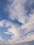 Panoramic cloudscape scene over the blue sky. Fluffy white clouds aerial composition. Misty overcast cumulus shapes, abstract